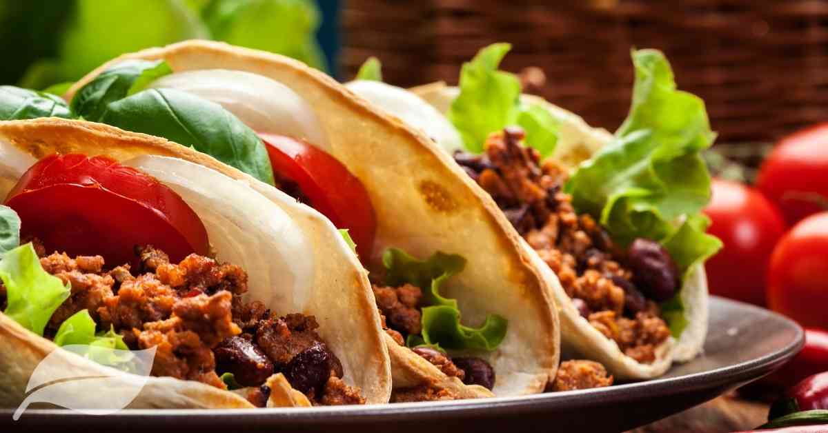 close up view of three mexican tacos