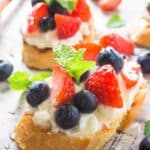 4th July Appetizer themed bruschetta with blueberries, cream cheese and strawberries