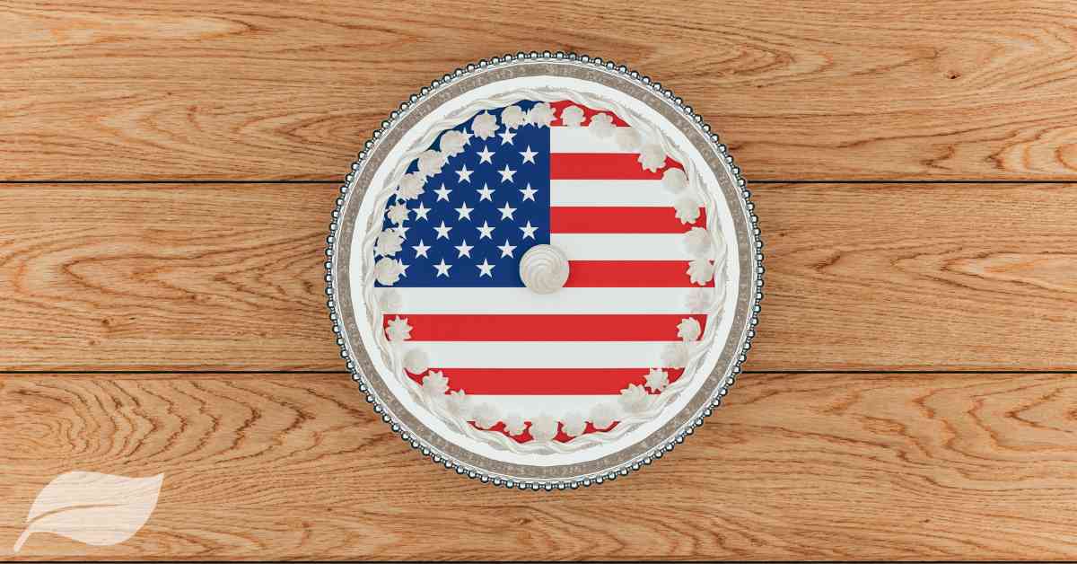 4th of july round cake with the american flag on top