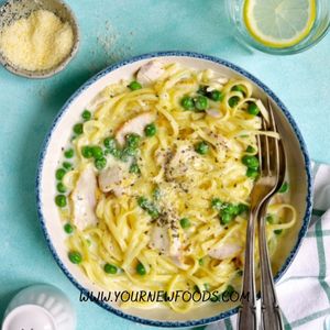 Italian recipes with Chicken carbonara in a white bowl on a blue surface