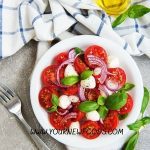 Italian salad recipes with a caprice salad on a white plate