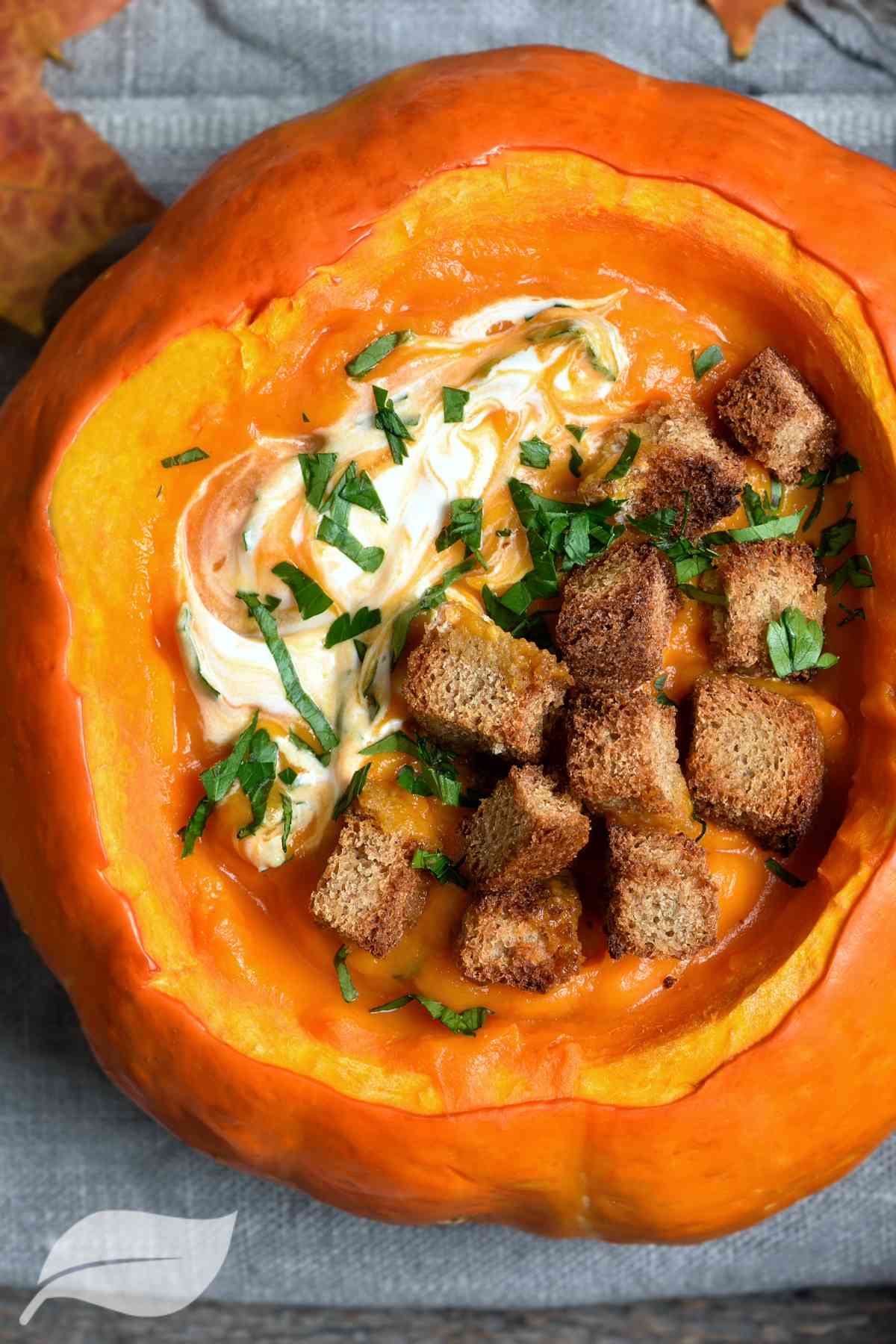 soup in a pumpkin with croutons and cream