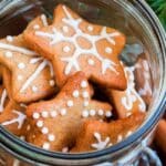 star shaped cookies with white festive frosting in a glass jar