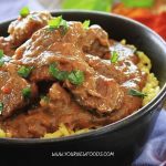 lamb curry in a black dish