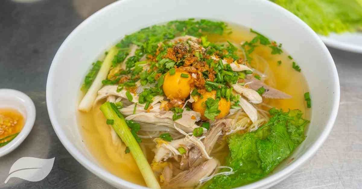 Vietnamese chicken soup with a full egg yolk in the centre