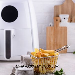 white air fryer with a basket of chips in the foreground