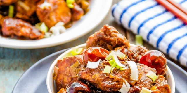 Classic Kung Pao Chicken in a black bowl chinese food recipes