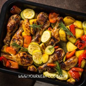 sheet pan full of cooked vegetables and chicken legs