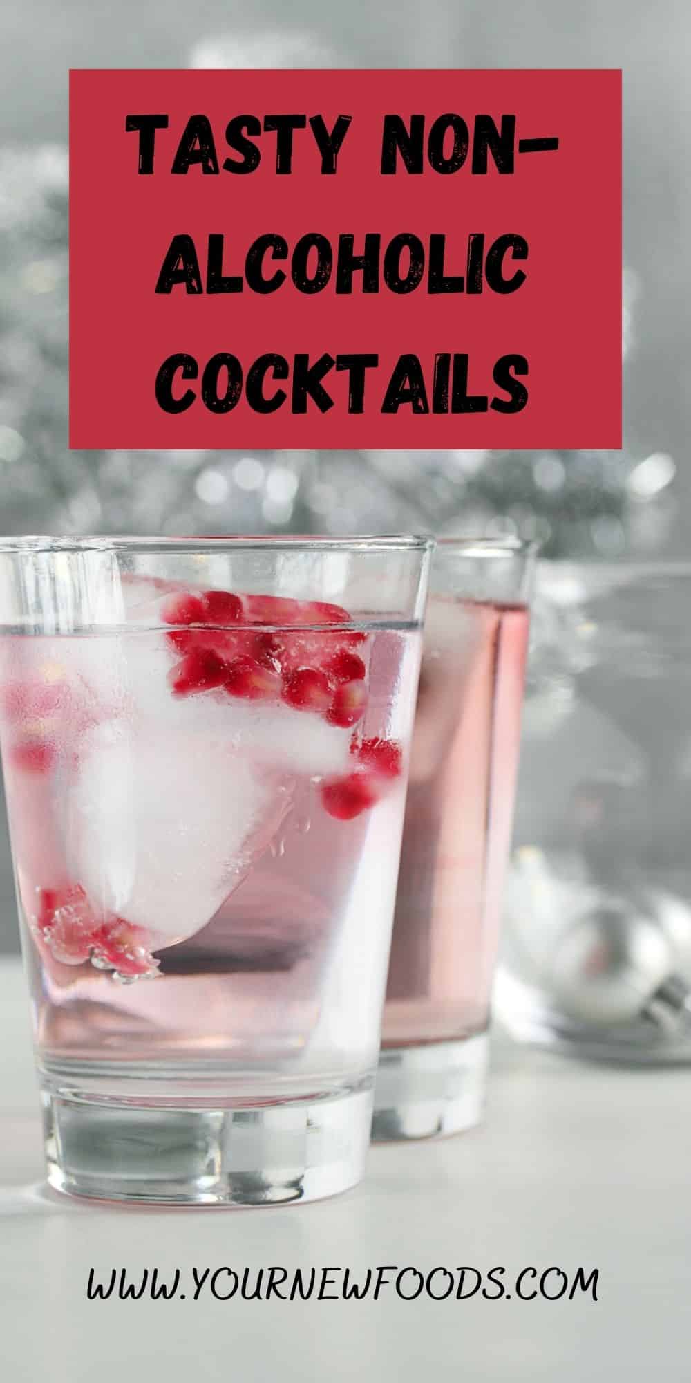 two non-alcoholic clear cocktails in tubmlers with a large ice cube and floating red berries
