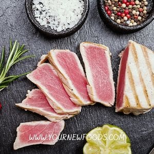 Fresh Tuna sliced on a black slate board