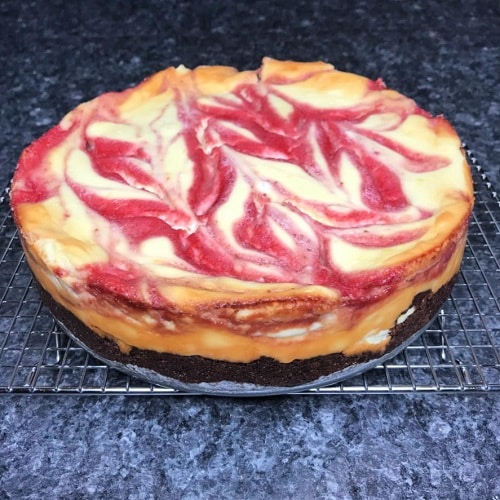 Keto Strawberry Swirl Cheesecake with an Oreo Cookie Crust