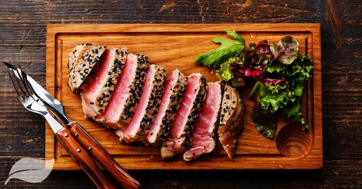 sliced tuna steak on a wooden board