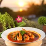 Thai Red Prawn Curry served in an outdoor setting during sunset