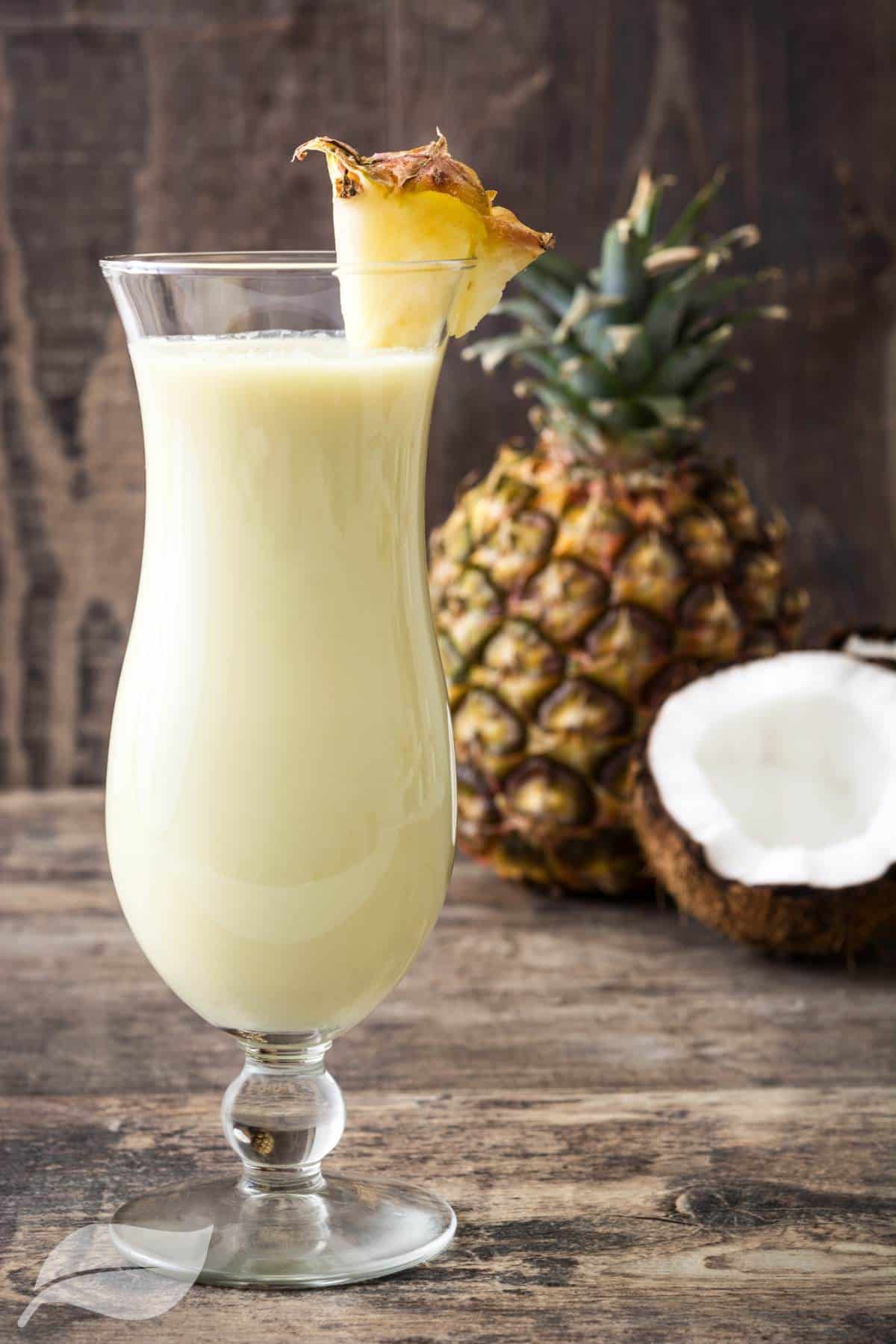 pina colada with pineapple next to the glass