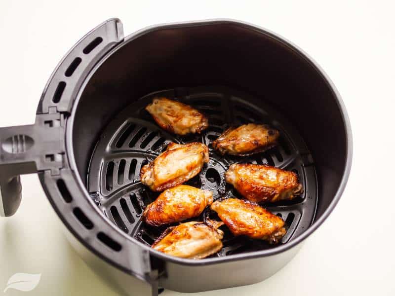 air-fryer chicken wings directly above photo in air fryer basket
